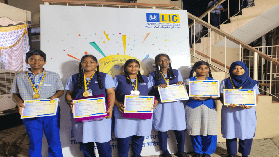 Students holding certificates from an essay writing competition