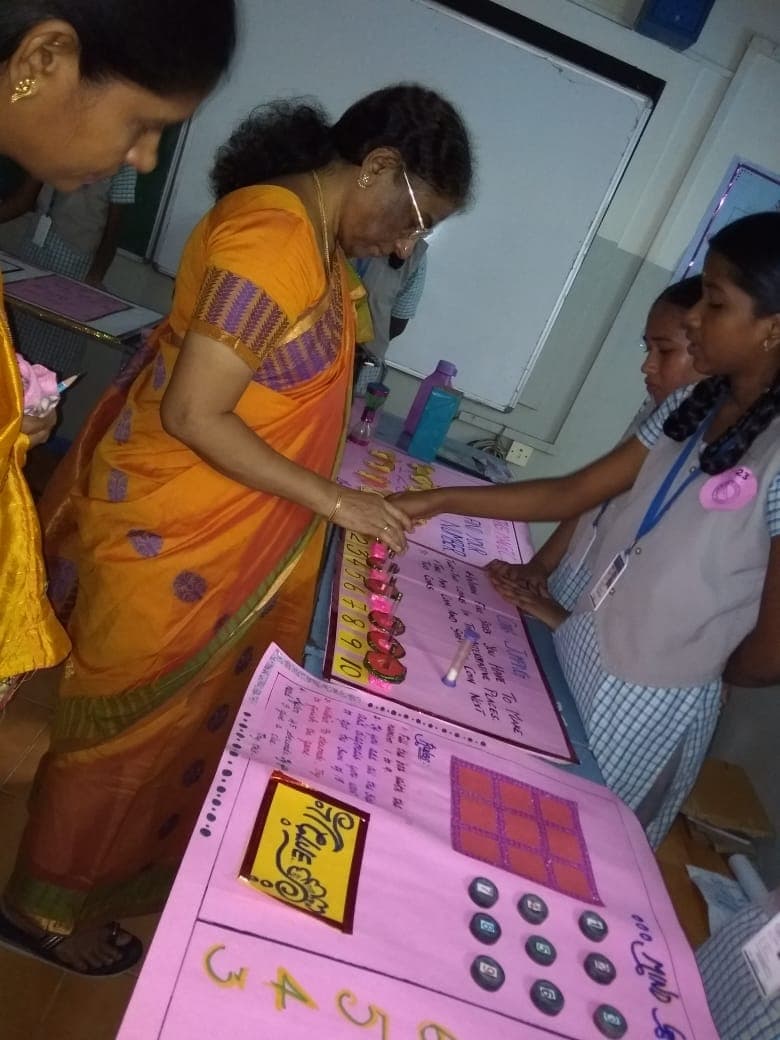 A student demonstrating a model at the mathematics exhibition
